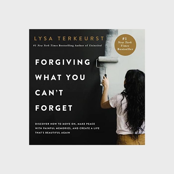 Person painting a wall black; book cover says 