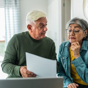 Senior couple using computer and doing home finances at home