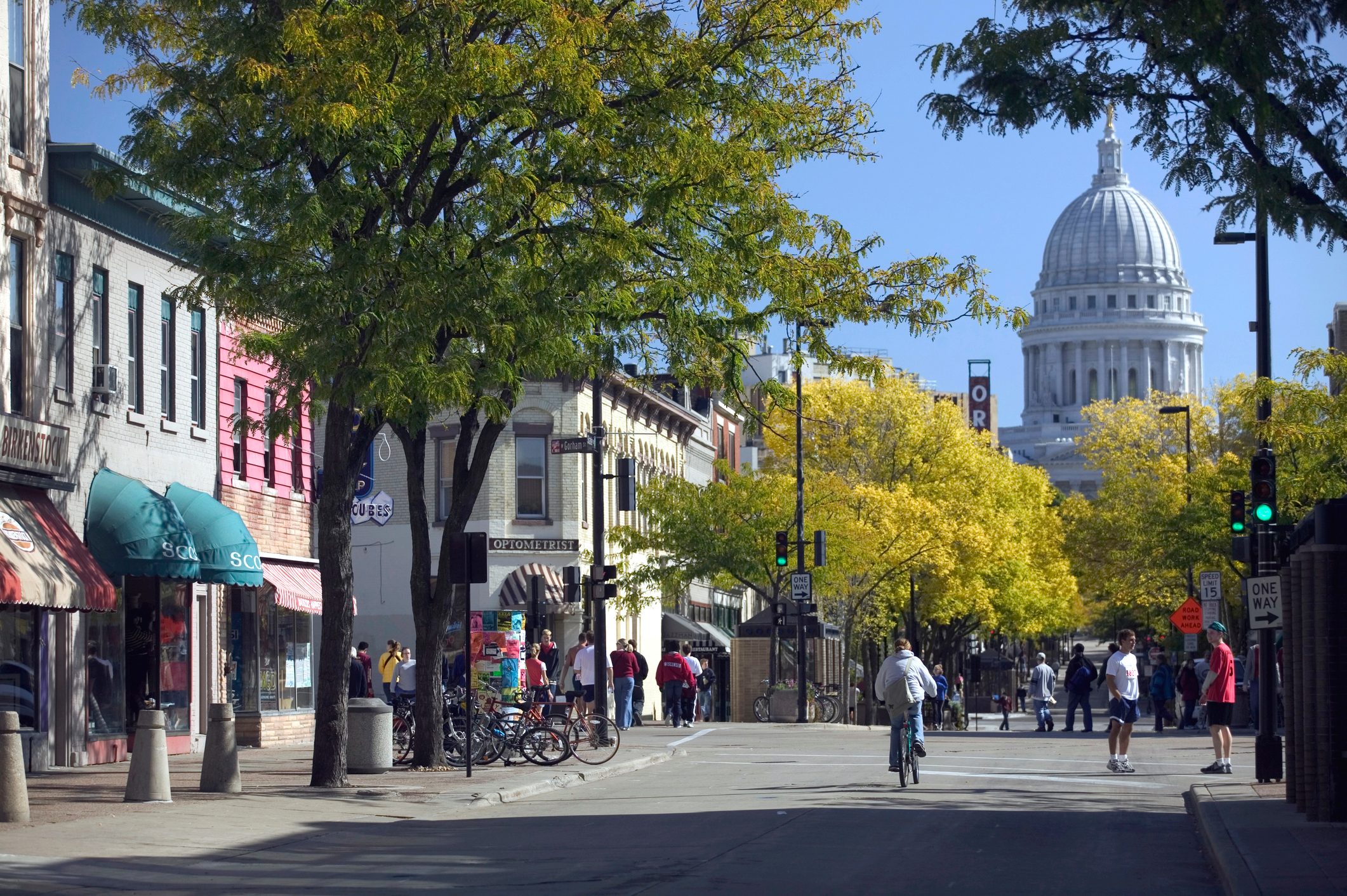 Tree-lined pedestrian Street in Madison, Wisconsin with a large capitol dome in the background