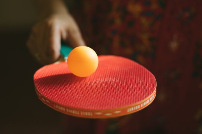 close up of ping pong racquet with a ball on it