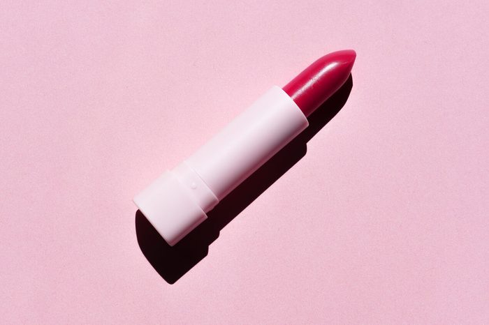 Red Lipstick Isolated on Pink Background