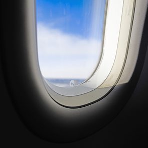 Plane in flight, window with sunlight