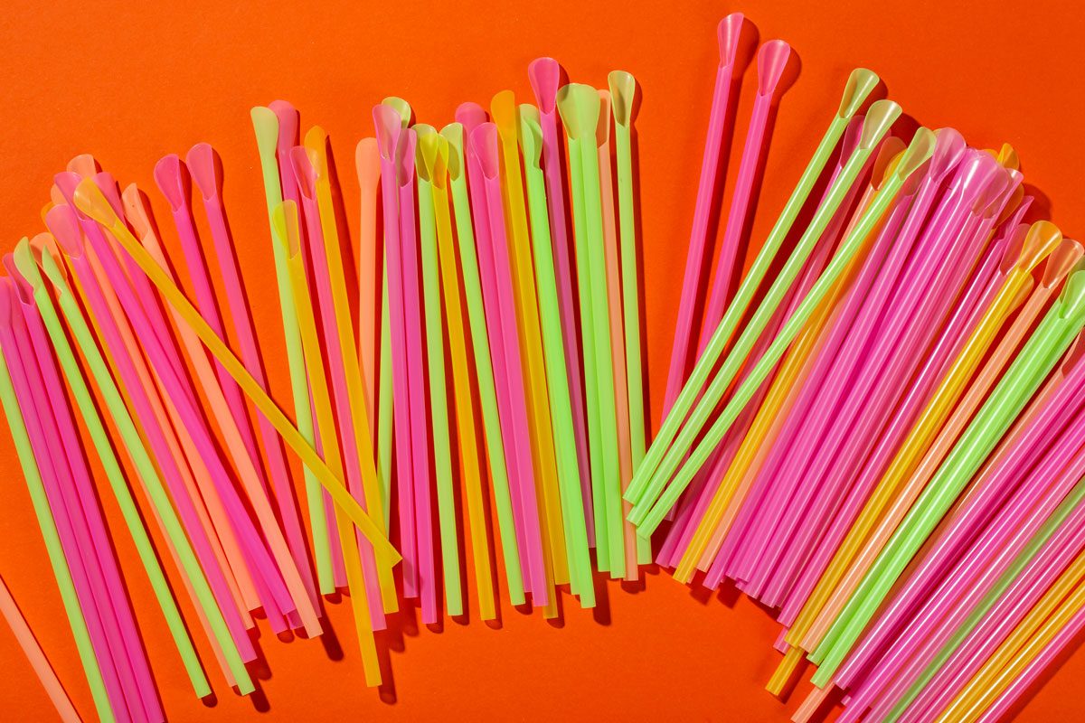 Colored Spoon Straws On Orange Background
