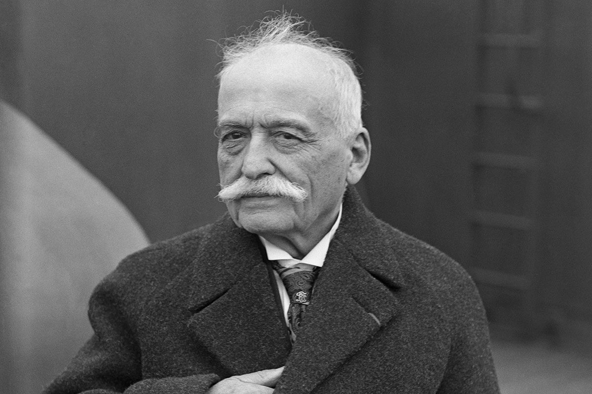 Auguste Escoffier, French chef at various first class hotels, is shown standing on a ship as it arrives in New York.